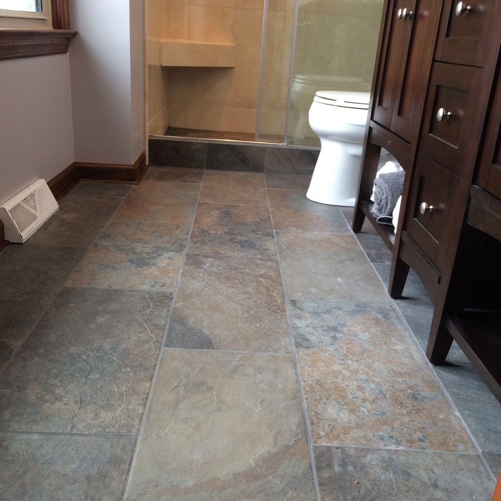 Mid-sized transitional master gray tile and porcelain tile porcelain tile alcove shower photo with shaker cabinets, dark wood cabinets, a two-piece toilet, gray walls, an undermount sink and granite countertops