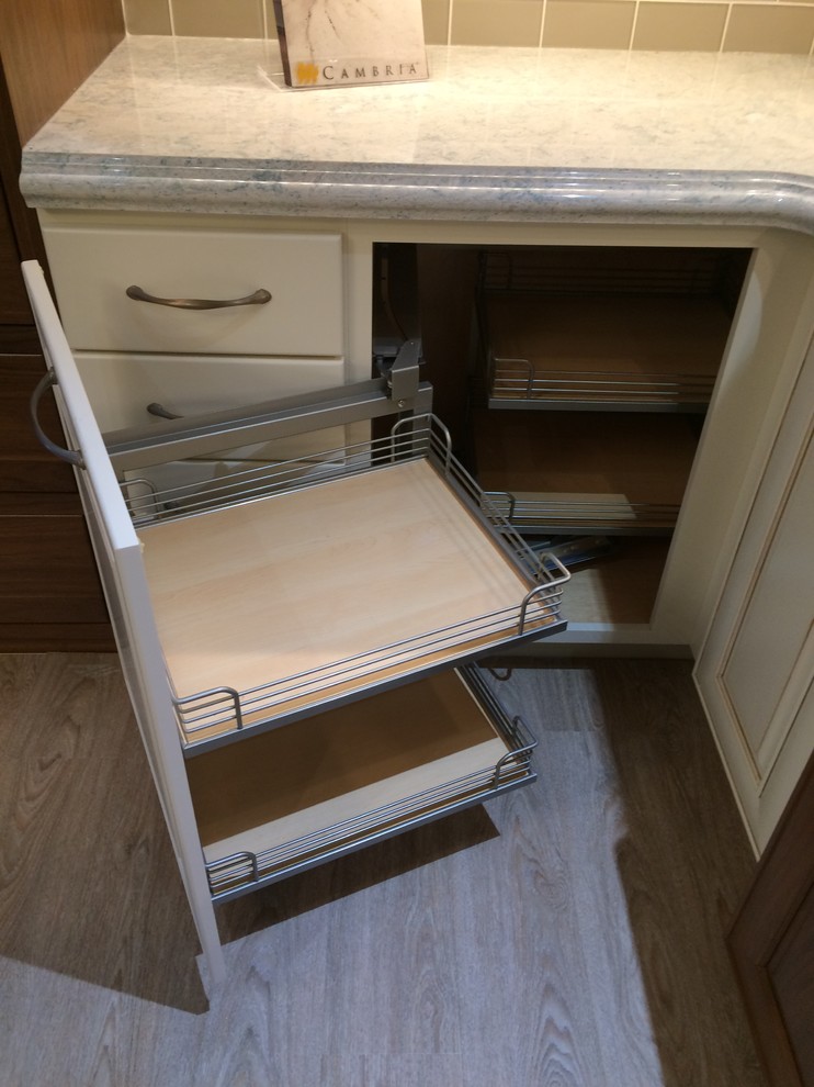 Mid-sized transitional u-shaped light wood floor eat-in kitchen photo in Milwaukee with raised-panel cabinets, white cabinets, an island, an undermount sink, quartzite countertops, gray backsplash, mosaic tile backsplash and stainless steel appliances