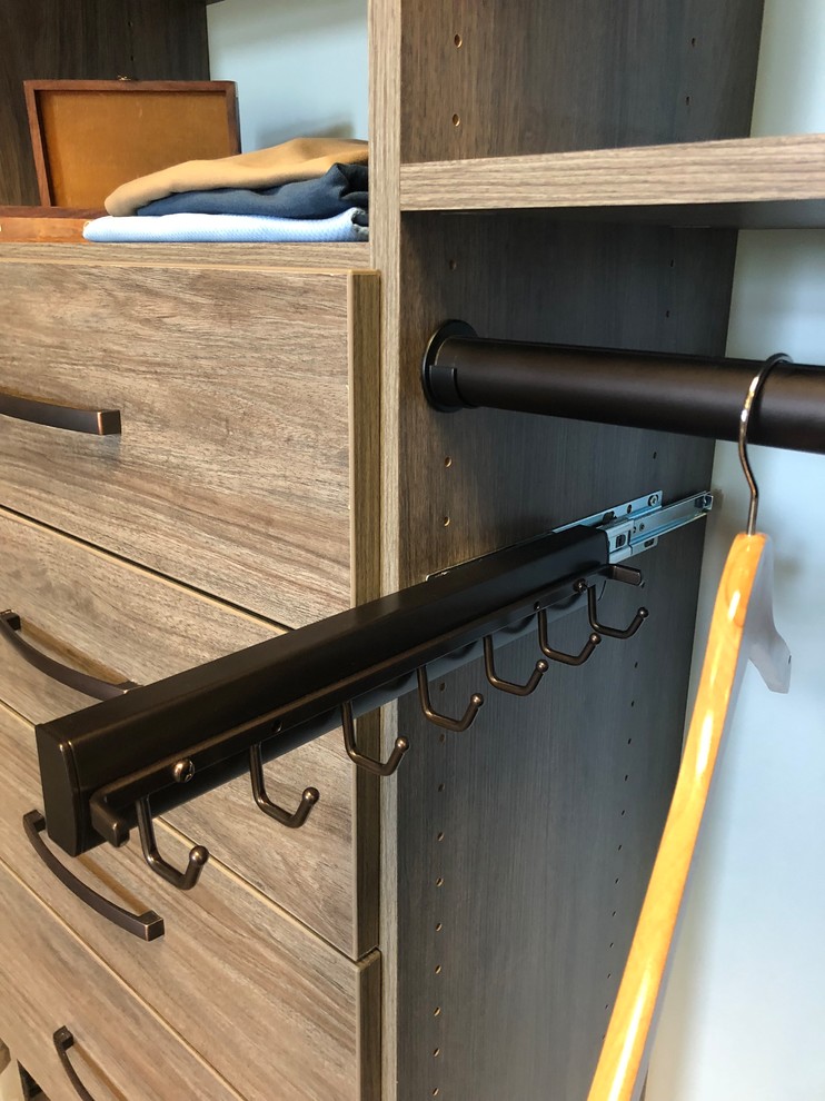 Inspiration for a transitional carpeted walk-in closet remodel with flat-panel cabinets and gray cabinets