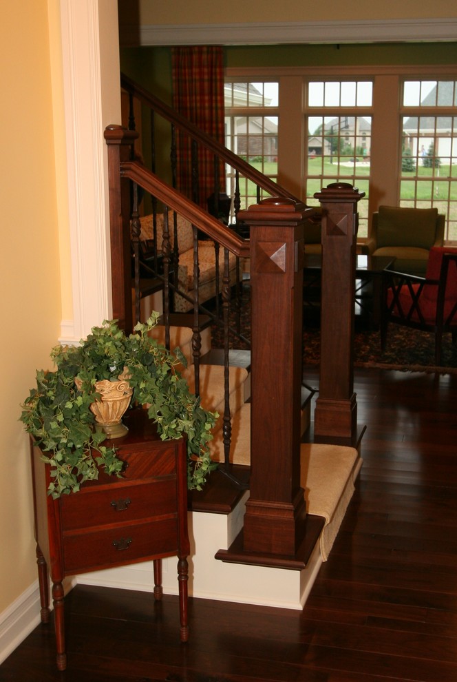 This is an example of a mid-sized traditional wood straight staircase in Indianapolis.