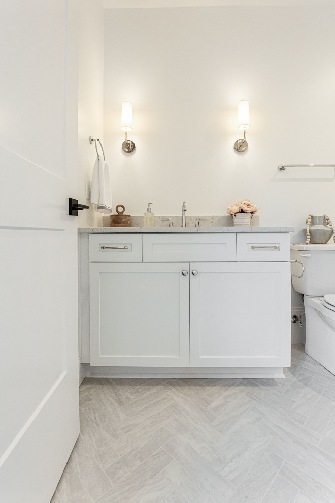 Mid-sized elegant kids' gray tile and porcelain tile porcelain tile, gray floor and single-sink bathroom photo in Atlanta with shaker cabinets, black cabinets, gray walls, an undermount sink, quartz countertops, a hinged shower door, white countertops and a built-in vanity