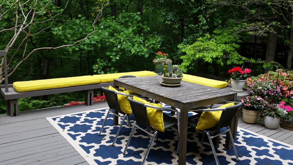 This is an example of a mid-sized modern backyard patio in DC Metro with no cover and decking.