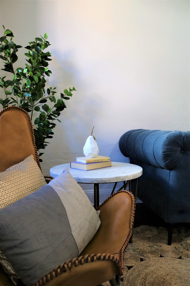 This is an example of a small victorian formal open concept living room in Newcastle - Maitland with grey walls, light hardwood floors, a standard fireplace, a wood fireplace surround and no tv.