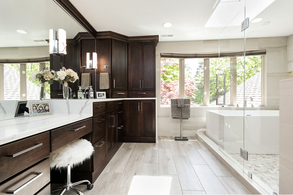 Transitional master bathroom in Detroit with flat-panel cabinets, dark wood cabinets, a freestanding tub, beige walls, beige floor, a hinged shower door and white benchtops.
