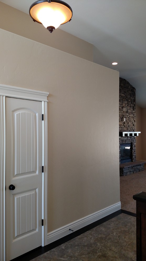 Inspiration for a large transitional ceramic tile foyer remodel with beige walls and a dark wood front door