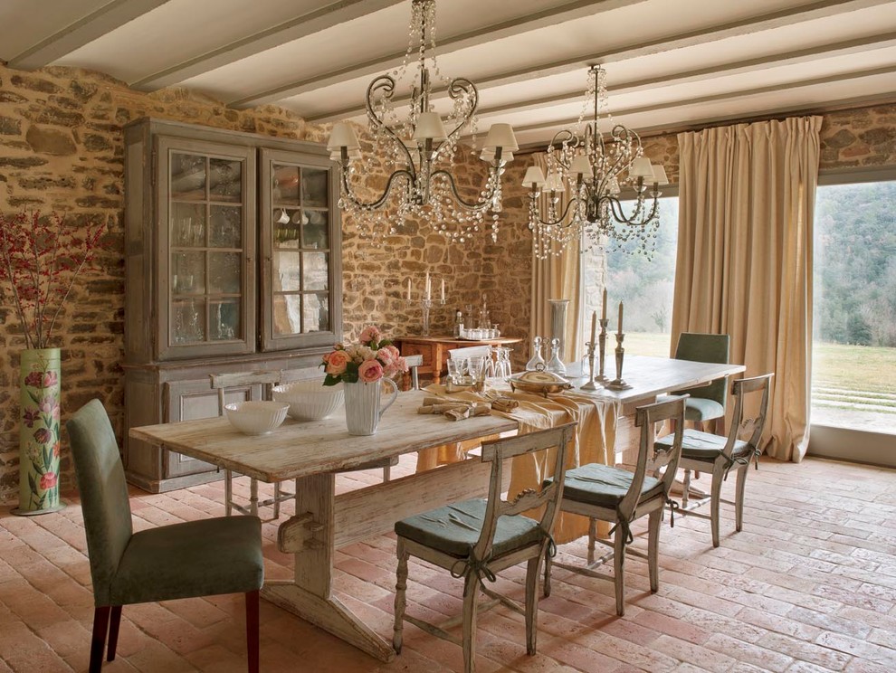 Mid-sized country open plan dining in Barcelona with brick floors, no fireplace and beige walls.