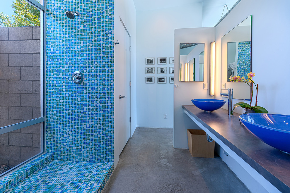 Photo of a modern bathroom in Other with mosaic tile, a vessel sink and blue tile.