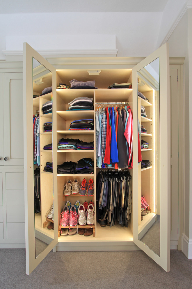 This is an example of a large traditional gender-neutral storage and wardrobe in Hampshire with carpet and open cabinets.