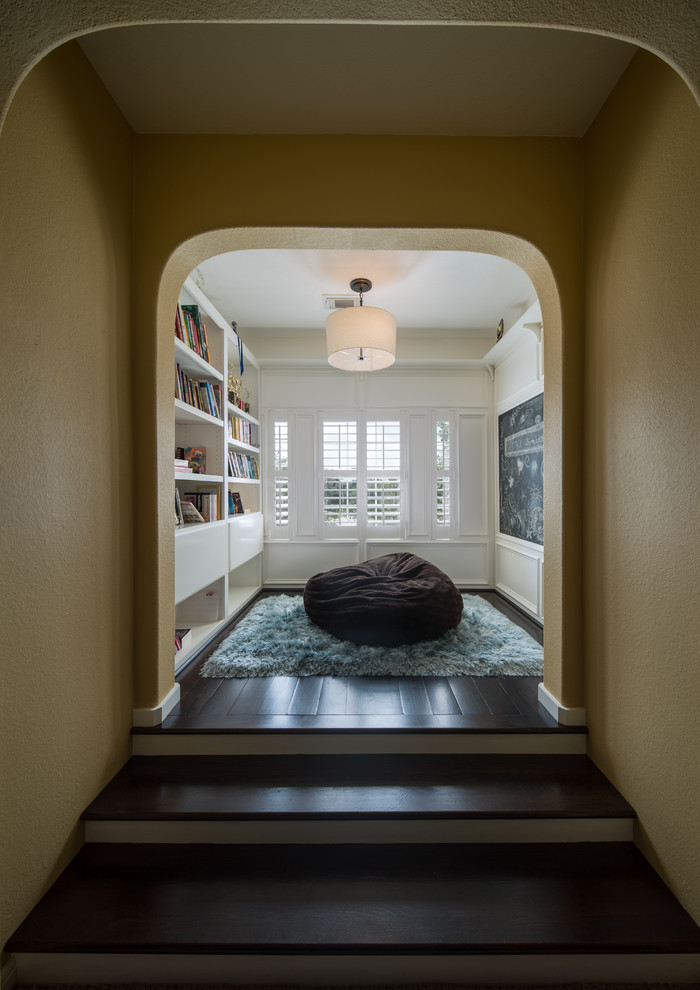 Photo of a small traditional gender-neutral kids' study room in Houston with dark hardwood floors.