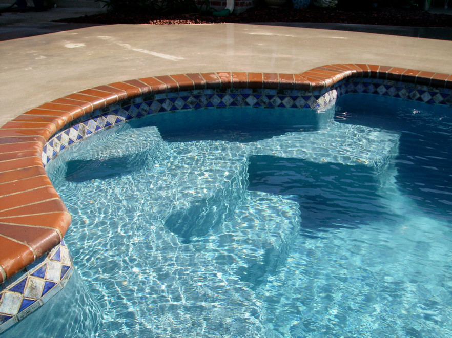 Large transitional backyard concrete and custom-shaped hot tub photo in St Louis