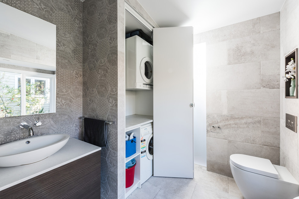 Design ideas for a mid-sized transitional master bathroom in Melbourne with flat-panel cabinets, dark wood cabinets, a claw-foot tub, an open shower, a one-piece toilet, gray tile, porcelain tile, grey walls, porcelain floors, a vessel sink, engineered quartz benchtops, grey floor and an open shower.