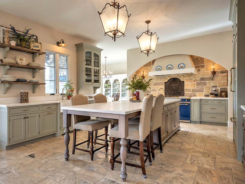 This is an example of a large transitional u-shaped open plan kitchen in Denver with a farmhouse sink, shaker cabinets, grey cabinets, quartzite benchtops, beige splashback, stone tile splashback, coloured appliances, with island, cement tiles and brown floor.