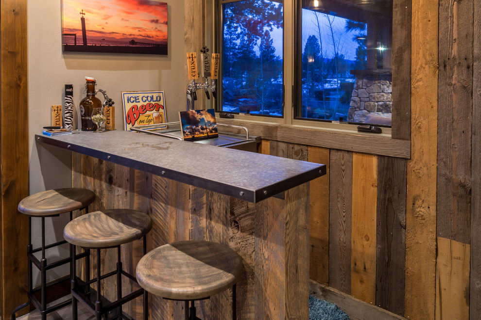 Photo of a small country l-shaped seated home bar in Other with distressed cabinets and stainless steel benchtops.