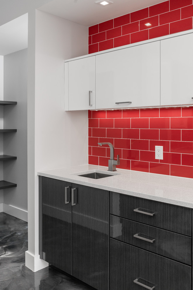 Design ideas for a mid-sized modern u-shaped open plan kitchen in Other with a drop-in sink, flat-panel cabinets, red splashback, ceramic splashback, stainless steel appliances, concrete floors, with island and grey floor.