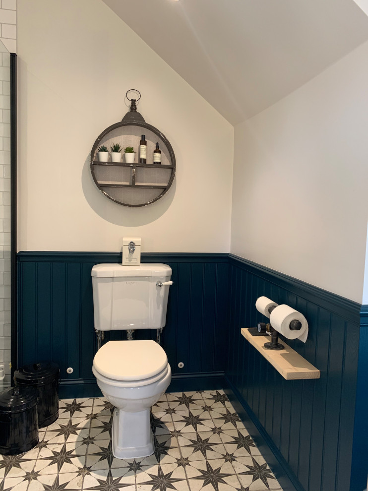 Design ideas for a large classic cloakroom in London with shaker cabinets, white cabinets, a two-piece toilet, white tiles, ceramic tiles, grey walls, porcelain flooring, a built-in sink, multi-coloured floors, a freestanding vanity unit, a drop ceiling and panelled walls.