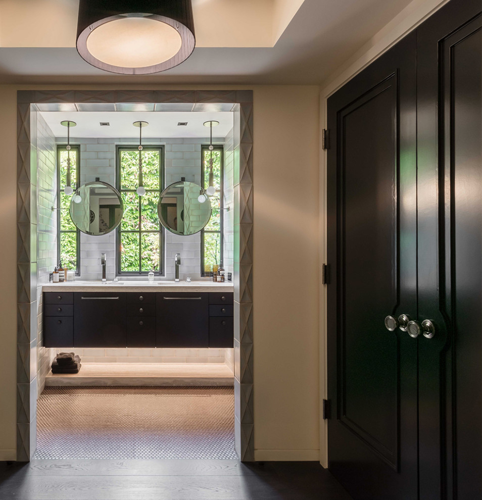 Photo of a midcentury gender-neutral storage and wardrobe in Seattle with dark wood cabinets and dark hardwood floors.