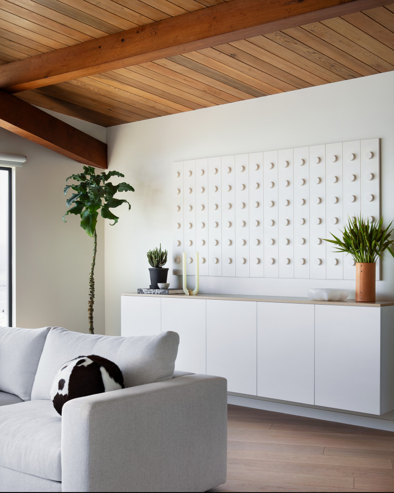 Example of a danish wood ceiling living room design in San Francisco with white walls