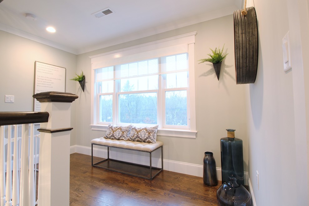 Example of a large transitional dark wood floor and brown floor hallway design in Boston with gray walls
