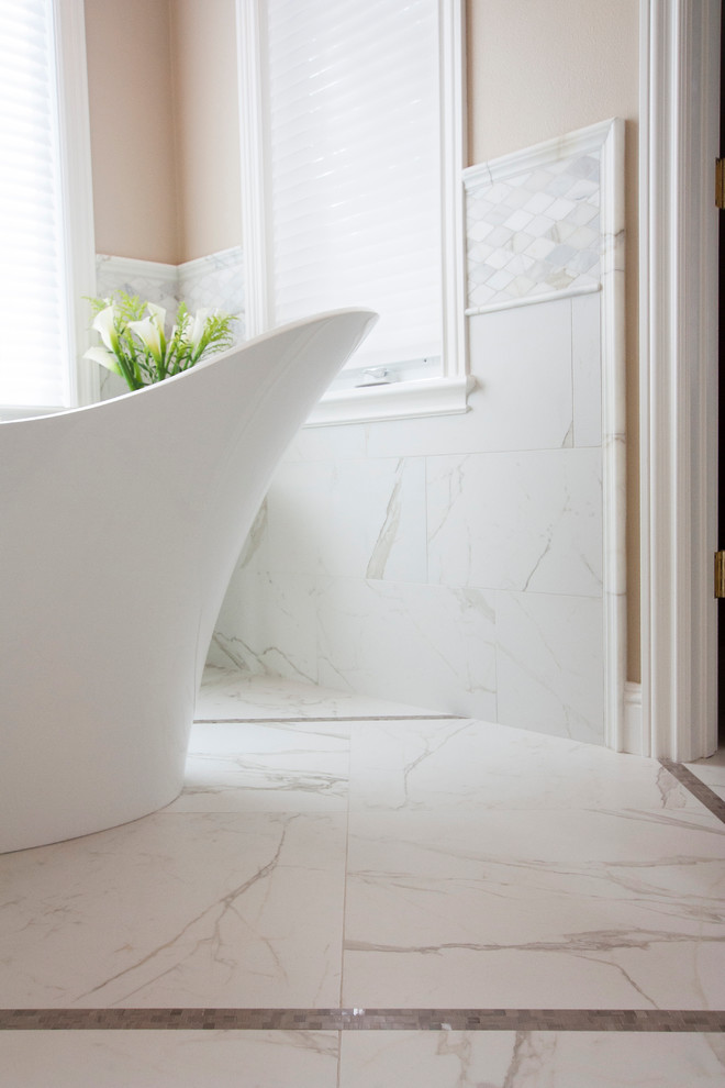 Inspiration for a large transitional master white tile and porcelain tile mosaic tile floor home design remodel with glass-front cabinets, white cabinets, a bidet, beige walls, an undermount sink and marble countertops