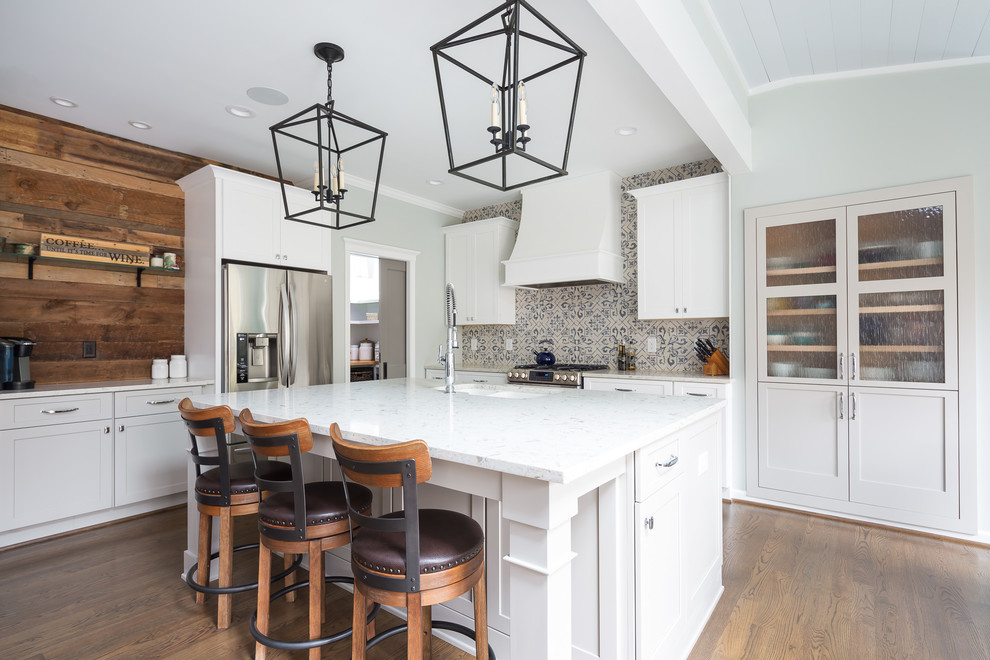 Example of a mid-sized transitional l-shaped porcelain tile and white floor eat-in kitchen design in Raleigh with an undermount sink, shaker cabinets, white cabinets, multicolored backsplash, porcelain backsplash, stainless steel appliances, an island, wood countertops and white countertops