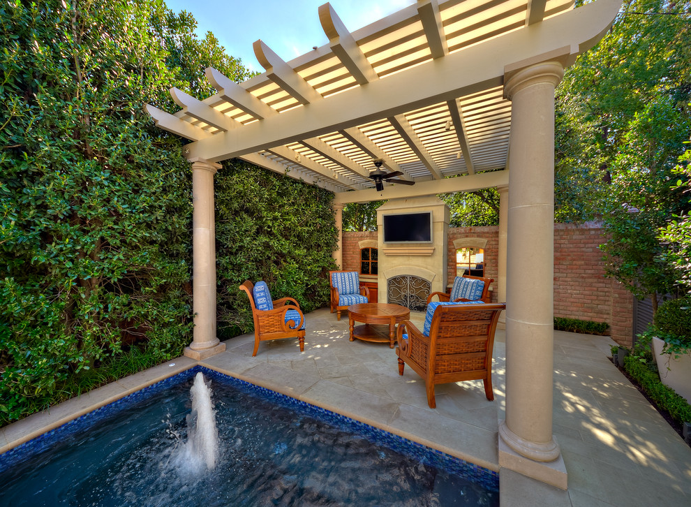 Inspiration for a traditional patio in Dallas with a pergola and a water feature.