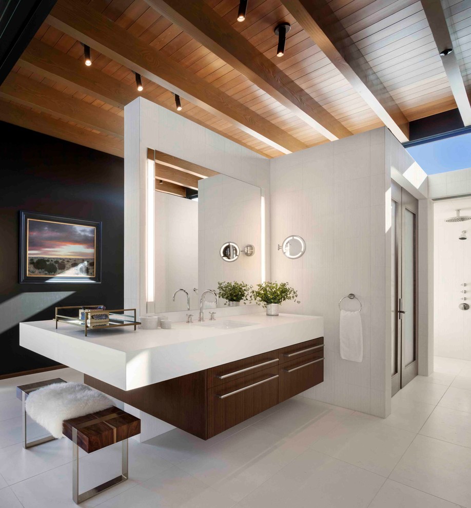 Contemporary bathroom in Denver with flat-panel cabinets, dark wood cabinets, grey walls, an undermount sink and grey floor.