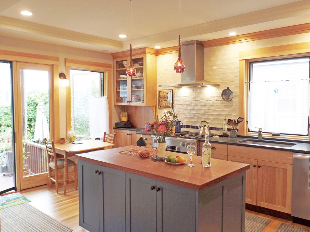 Inspiration for a mid-sized contemporary l-shaped light wood floor and beige floor eat-in kitchen remodel in Other with a single-bowl sink, shaker cabinets, light wood cabinets, soapstone countertops, white backsplash, subway tile backsplash, stainless steel appliances, an island and gray countertops