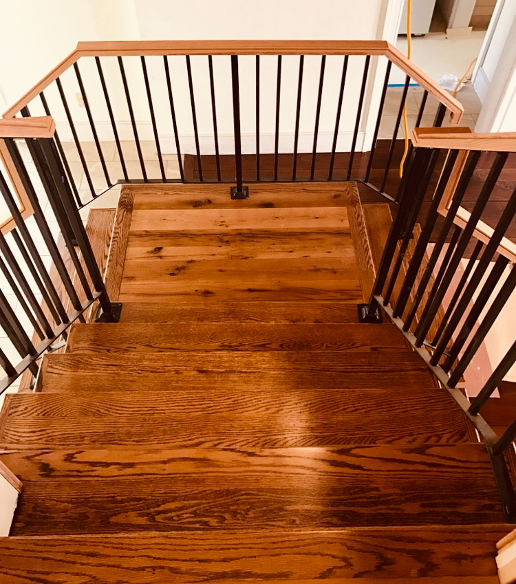This is an example of a large transitional wood l-shaped staircase in Philadelphia with wood risers and mixed railing.