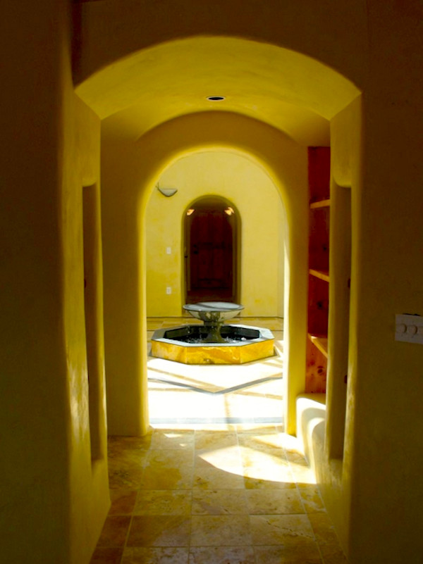 Example of a mid-sized transitional travertine floor front door design in Albuquerque with yellow walls and a medium wood front door