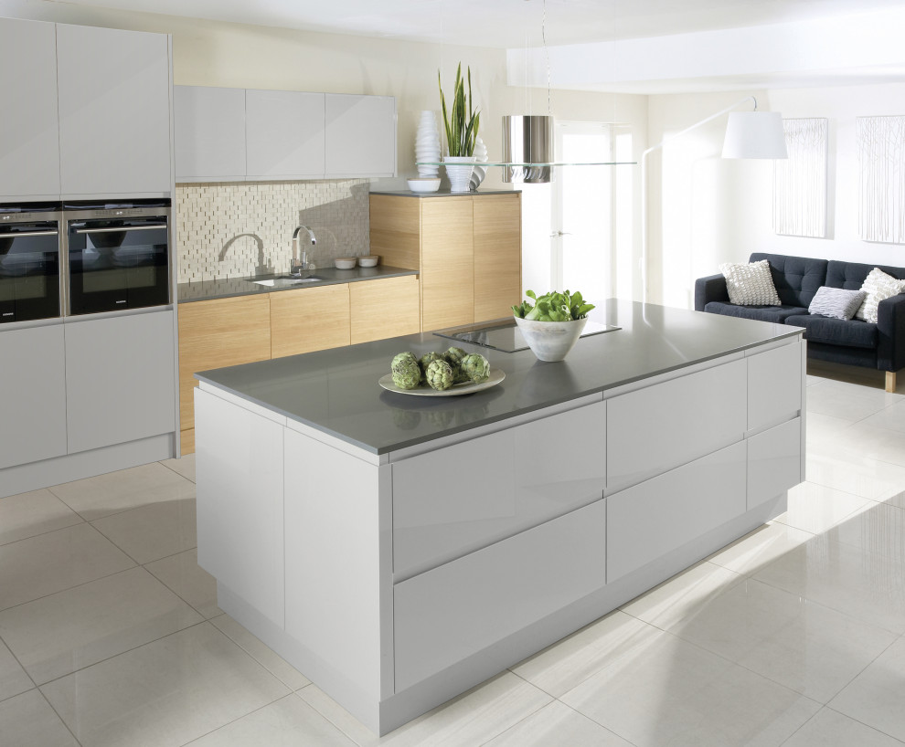 Design ideas for a modern eat-in kitchen in Other with white cabinets, beige splashback, with island and grey benchtop.