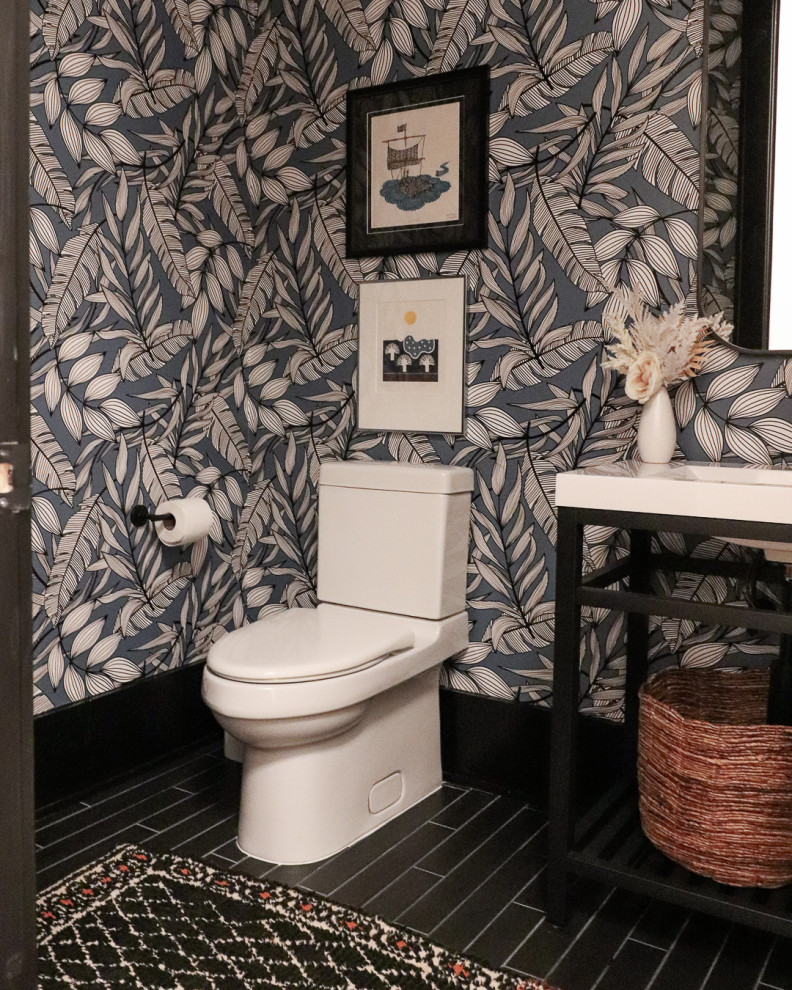 Inspiration for a small modern powder room in Birmingham with a one-piece toilet, porcelain floors, a console sink, solid surface benchtops, white benchtops, a freestanding vanity and wallpaper.