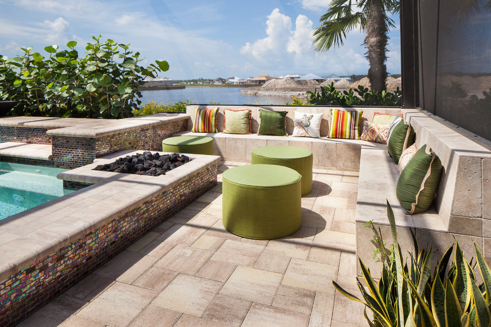 Photo of a mid-sized asian backyard patio in Miami with a fire feature, natural stone pavers and no cover.