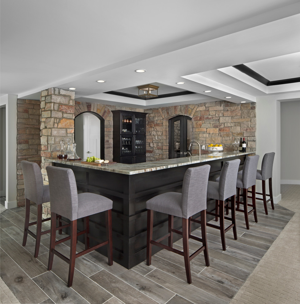Inspiration for a large transitional l-shaped seated home bar in Detroit.