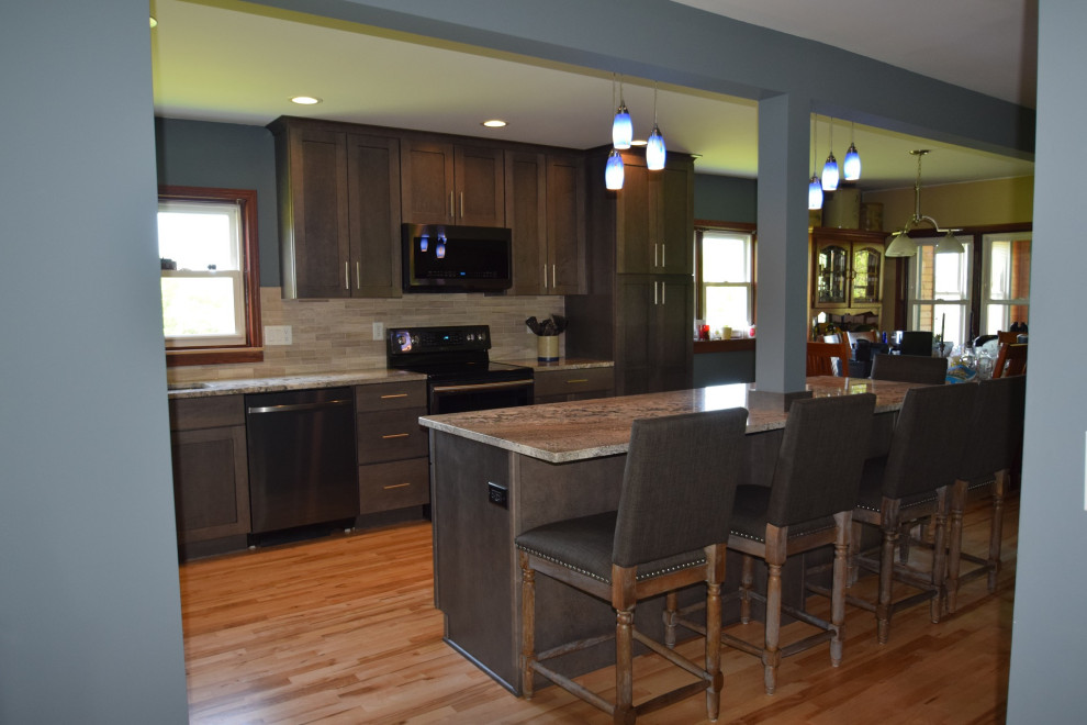 Eat-in kitchen - transitional l-shaped light wood floor eat-in kitchen idea with an undermount sink, shaker cabinets, gray cabinets, granite countertops, multicolored backsplash, stone tile backsplash, stainless steel appliances, an island and multicolored countertops