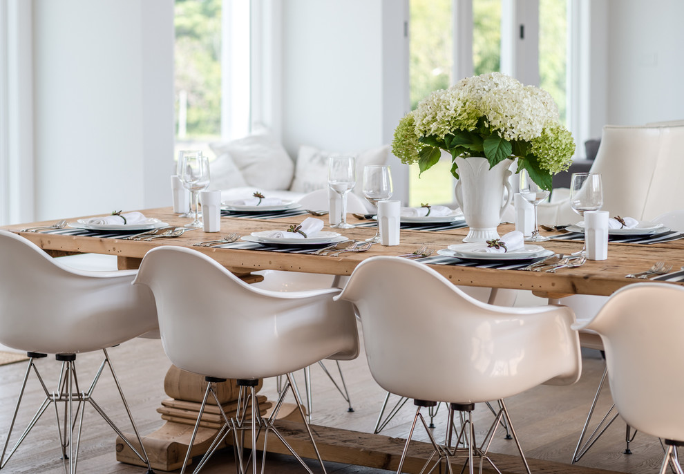 Inspiration for an expansive beach style open plan dining in Toronto with white walls and medium hardwood floors.