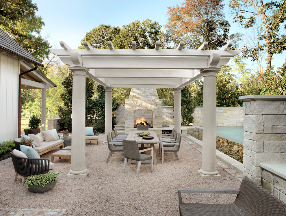 Photo of a country backyard patio in Austin with gravel, a pergola and with fireplace.
