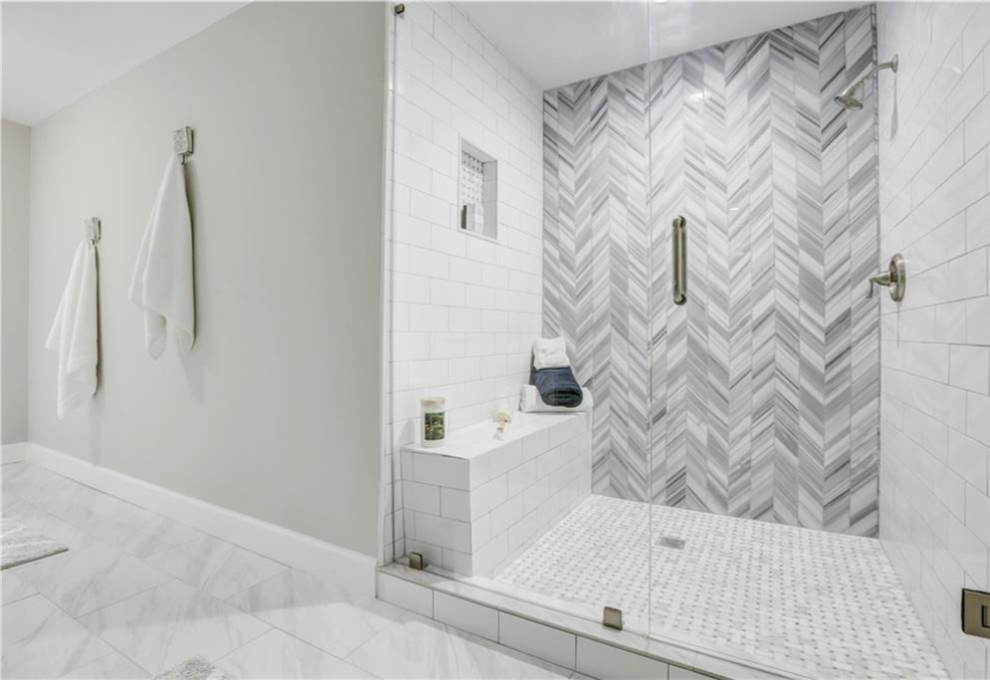 Design ideas for a mid-sized transitional master bathroom in Atlanta with a freestanding tub, marble floors, marble benchtops, multi-coloured floor and a hinged shower door.