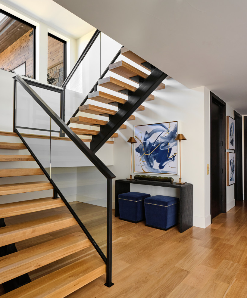Inspiration for a huge contemporary wooden u-shaped glass railing staircase remodel in Denver with wooden risers