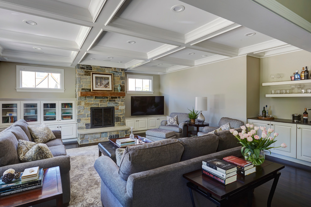 This is an example of a large country open concept family room in Chicago with beige walls, dark hardwood floors, a standard fireplace, a stone fireplace surround and a built-in media wall.