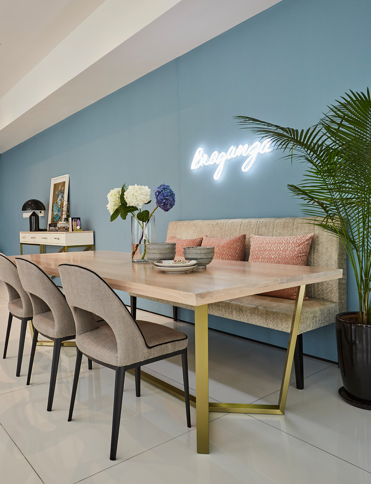Inspiration for a contemporary dining room in Singapore with blue walls and white floor.
