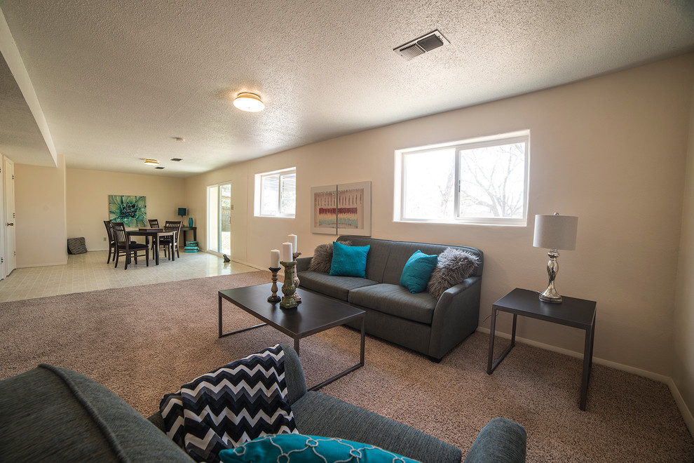 This is an example of an expansive contemporary open concept family room in Albuquerque with a game room, beige walls, no fireplace and carpet.