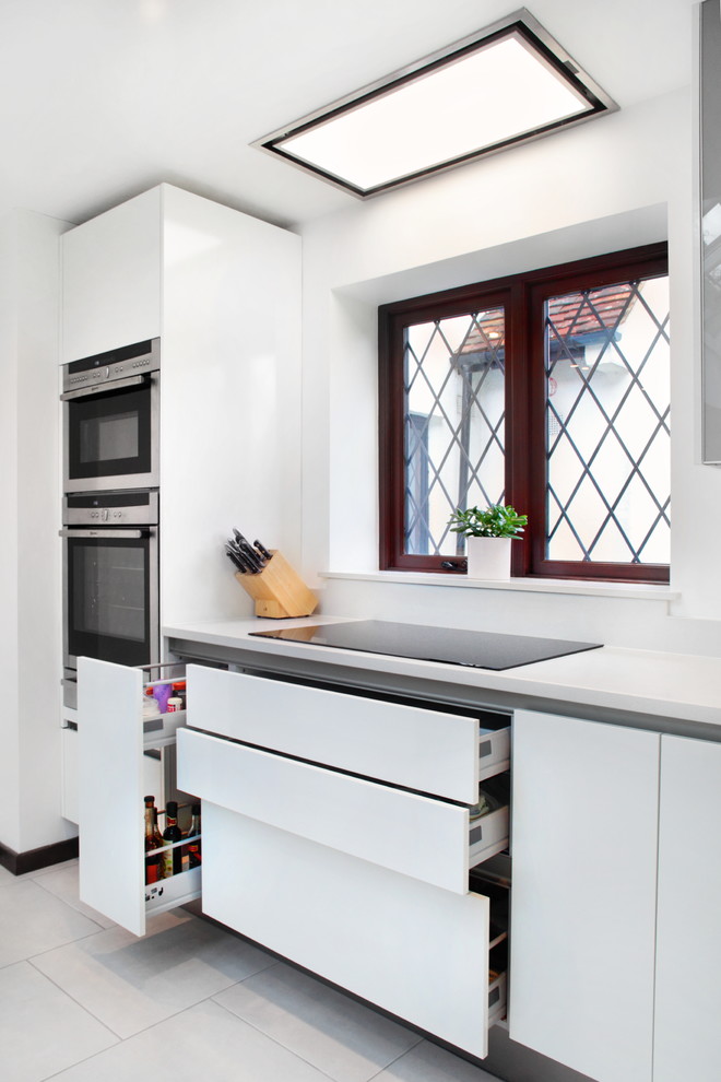 Contemporary white kitchen with built in storage ...