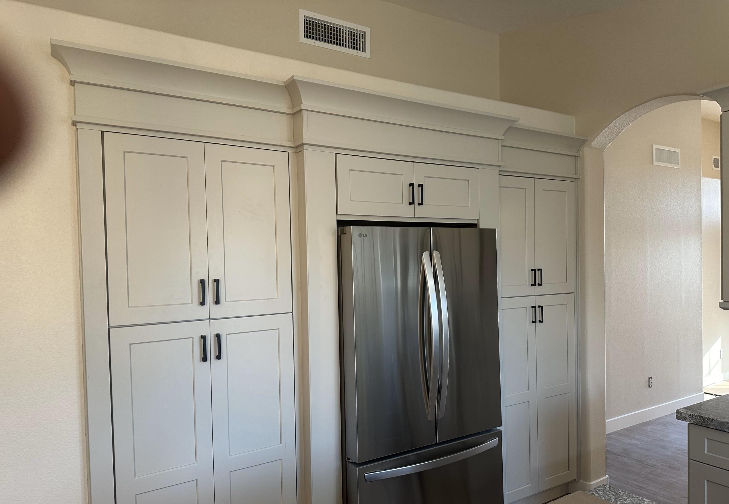 A pantry- refrigerator housing for optimal space and functionality.