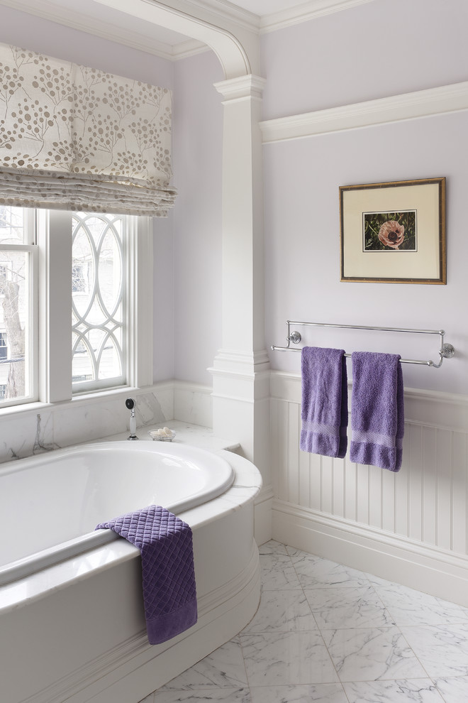 Traditional master bathroom in Boston with a drop-in tub, white cabinets, marble benchtops, white tile and purple walls.