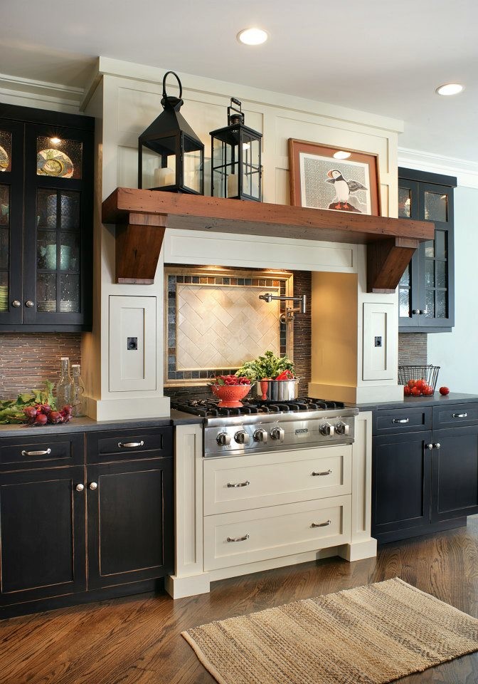 Inspiration for a mid-sized traditional eat-in kitchen in New York with recessed-panel cabinets, black cabinets, limestone benchtops, brown splashback, stainless steel appliances and medium hardwood floors.