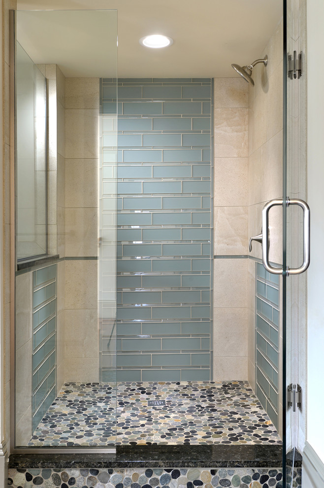 This is an example of a transitional bathroom in New York with flat-panel cabinets, an open shower, pebble tile floors, blue tile and glass tile.