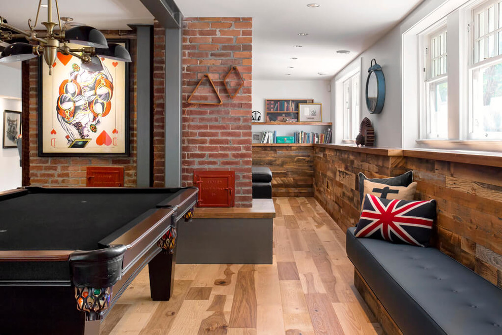 Industrial look-out basement in Vancouver with a game room, white walls and medium hardwood floors.