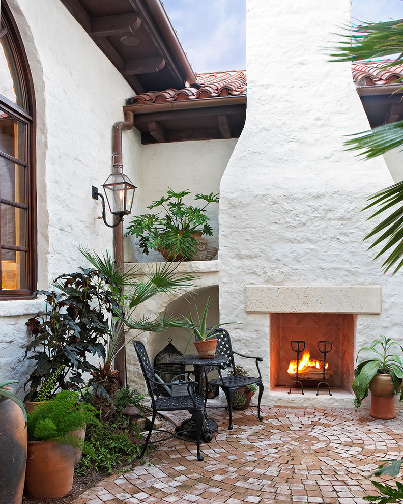 Inspiration for a mediterranean courtyard patio in Austin with a fire feature.
