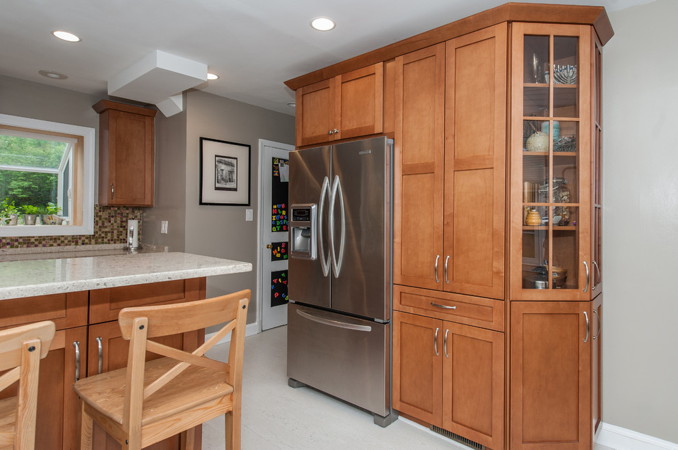 Inspiration for a large transitional galley cork floor eat-in kitchen remodel in DC Metro with an undermount sink, shaker cabinets, brown cabinets, quartz countertops, multicolored backsplash, glass tile backsplash and stainless steel appliances