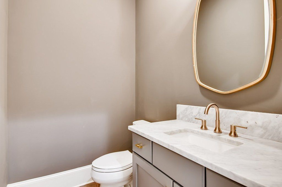 Mid-sized transitional powder room in Atlanta with shaker cabinets, grey cabinets, grey walls, an undermount sink, marble benchtops, white benchtops and a freestanding vanity.